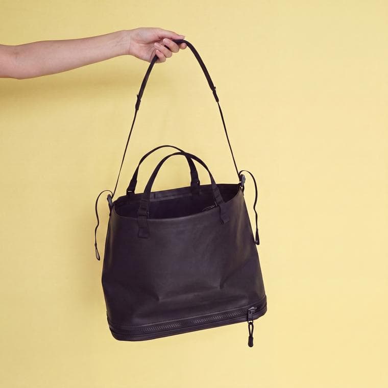 Sunday Proof bag in black, hanging closed, with the zip line visible around the base